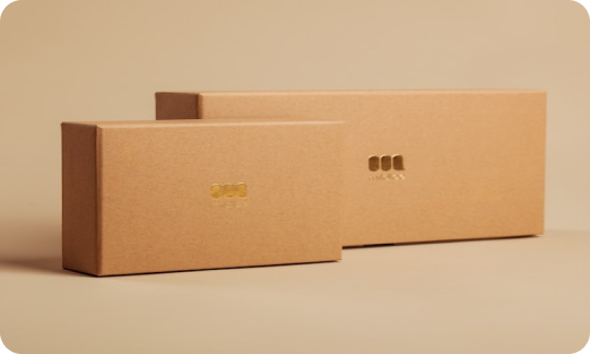 Two Brown Boxes With Gold Designs in the Center